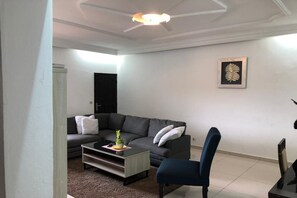 Economy Apartment | Living area | 40-inch flat-screen TV with satellite channels, TV