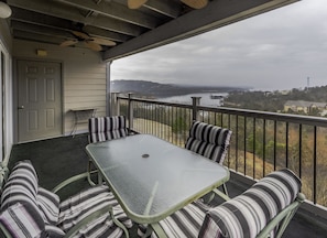 Enjoy the serene views of the water and surrounding landscape from this balcony.