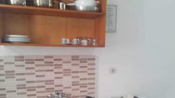 Fridge, stovetop, cookware/dishes/utensils, dining tables