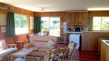 A cozy cabin with a living area, dining space, and a small kitchen.