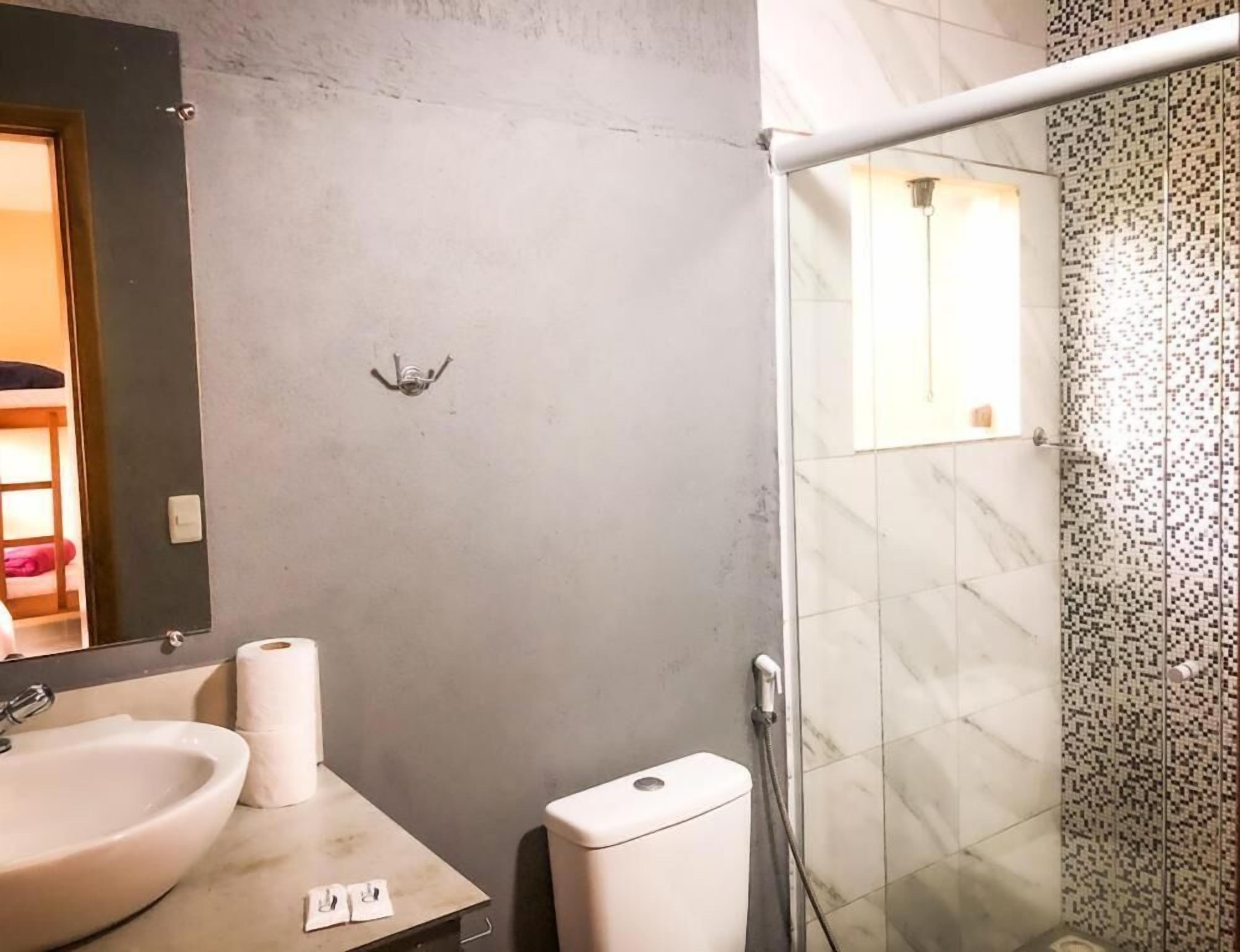 A bathroom with a sink, toilet, and shower.