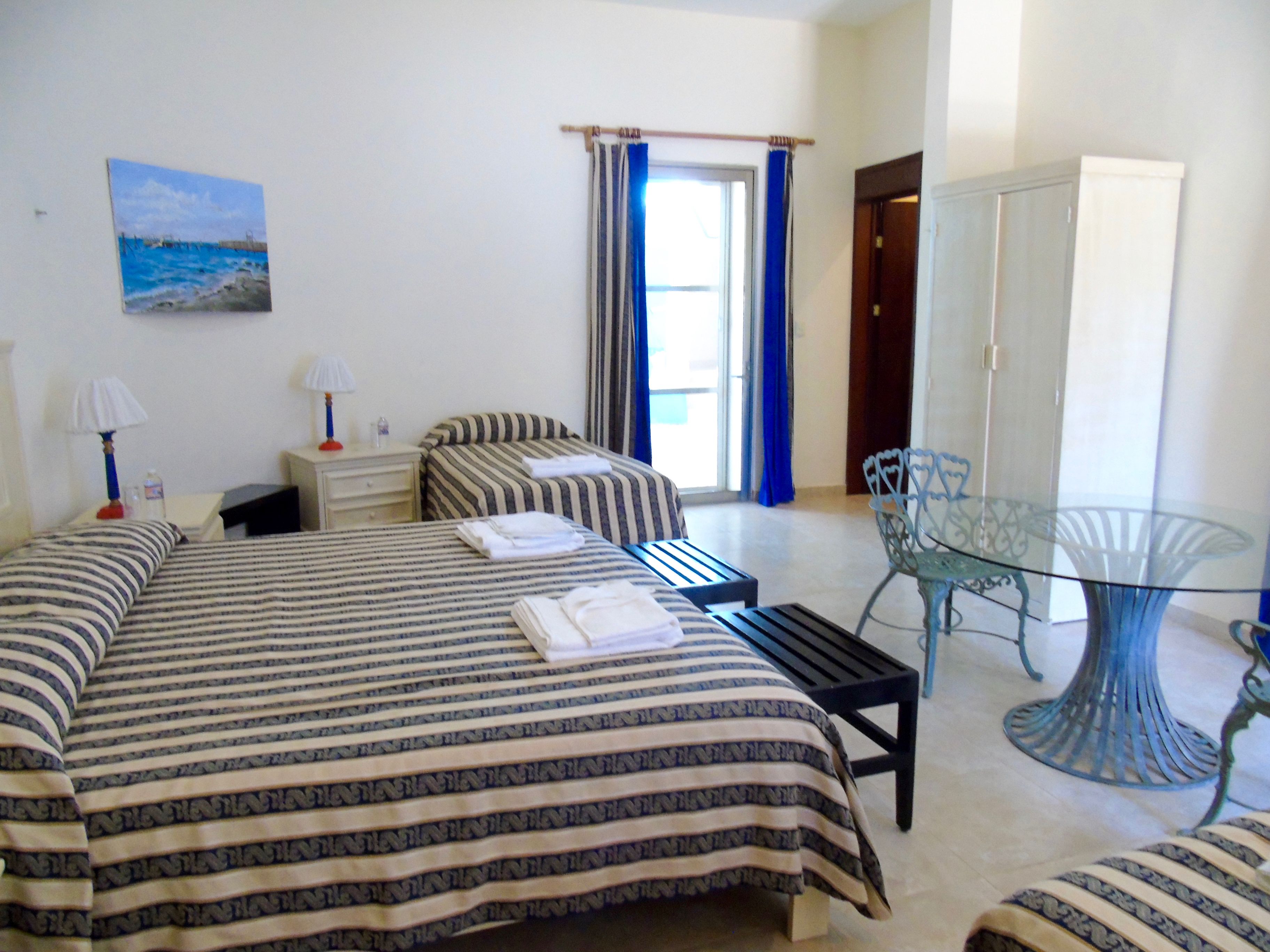 Standard Quadruple Room, Garden View | Individually decorated, individually furnished, desk, laptop workspace