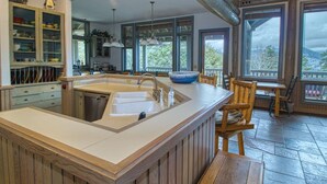 A kitchen with a large island, wooden cabinets, and a view of the outdoors. - Eagles Rest:Mountain views>Huge home>Hiking (#23-ZONE3439) (Estes Park)