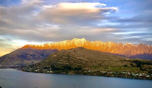 Un paisaje montañoso con un lago y un pequeño pueblo.