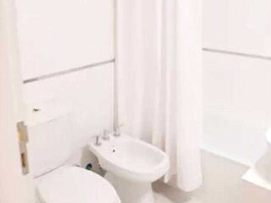 A bathroom with a toilet, bidet, and a shower area.
