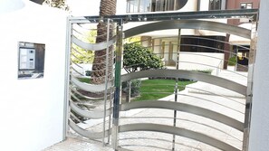 Stylish entrance with a modern gate leading to a beautifully maintained building.