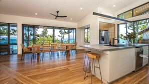 Enjoy cooking in this well-equipped kitchen with a central island and bar stools, offering a view of the outdoors.