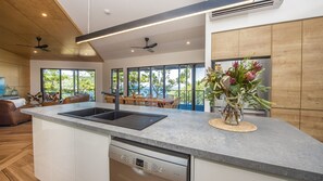 Enjoy cooking in this well-equipped kitchen with a large island, dishwasher, and spacious countertop.