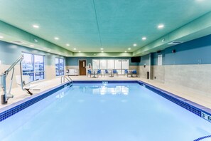 An indoor swimming pool with clear blue water, a tiled edge, and a ceiling with recessed lighting. - Holiday Inn Express & Suites Springfield North (Springfield)