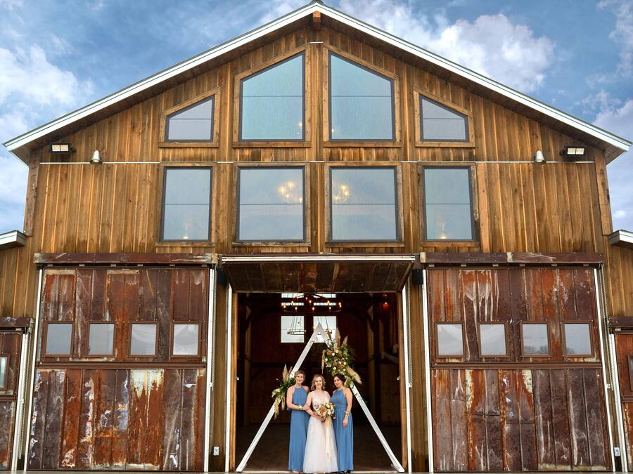 A rustic barn-style building with large windows and a prominent entrance.