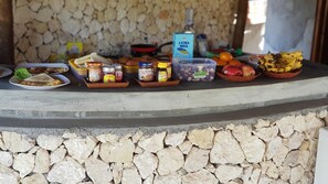 A breakfast buffet with various food items and condiments. - Gading Treehouse (Penida Island)