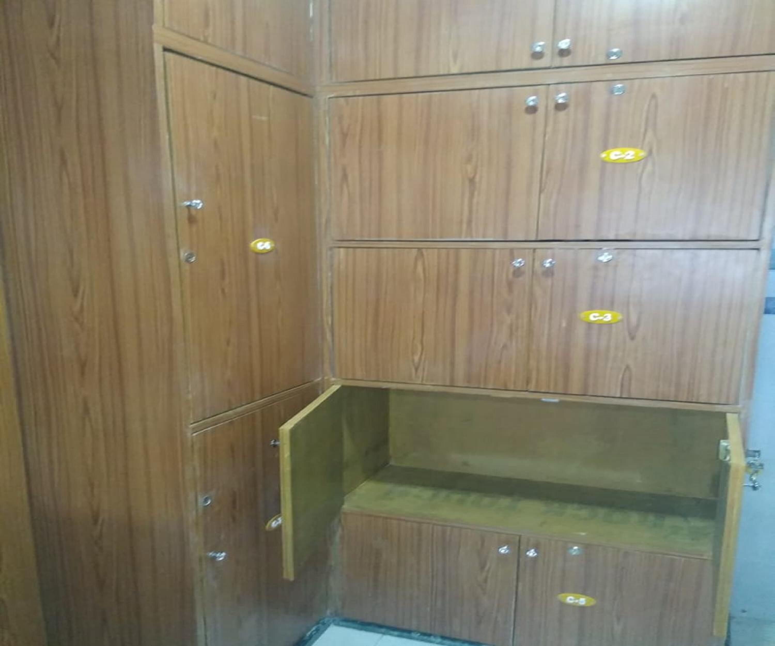 A corner of a room with wooden cabinets, each marked with a number.