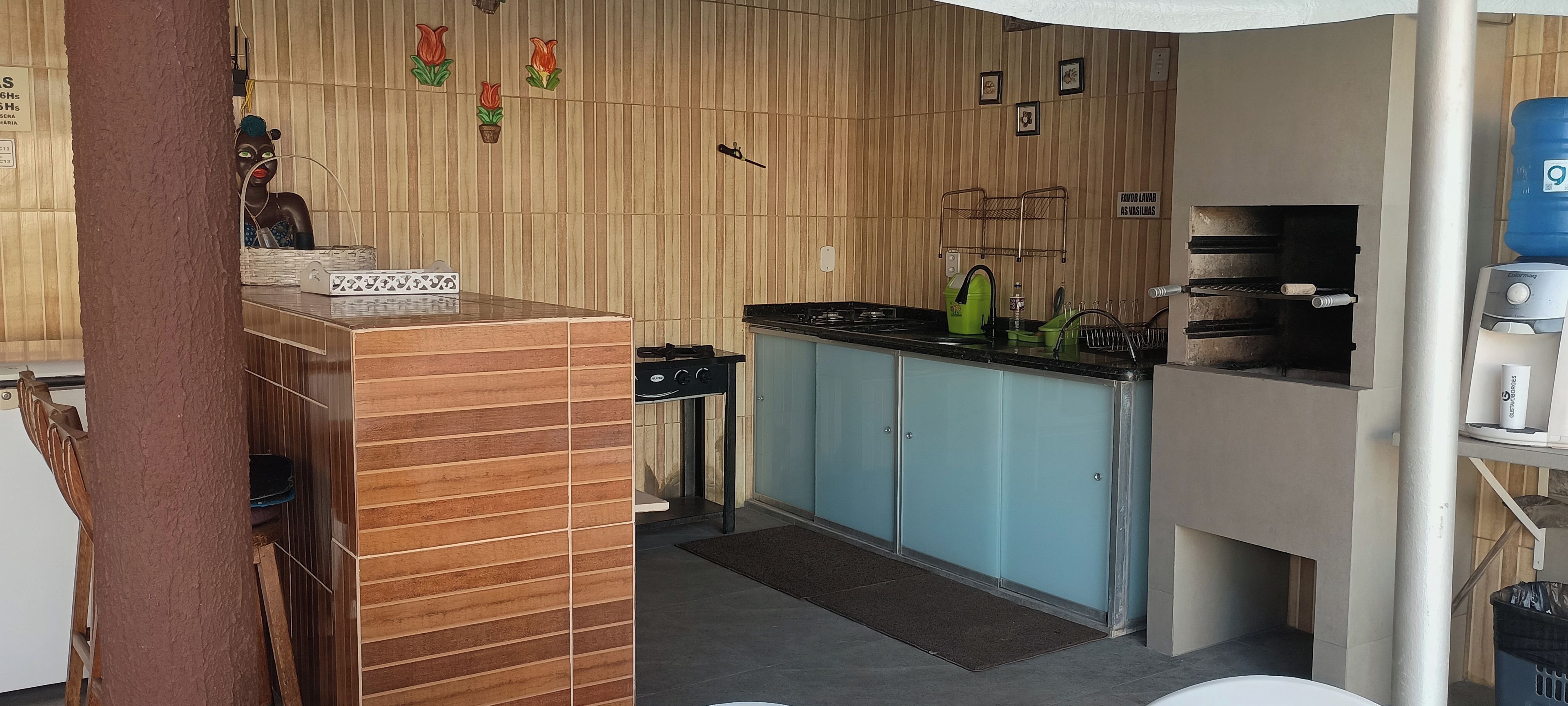 A compact kitchen with a stove, sink, and cabinets.