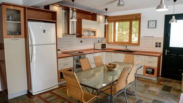 Villa | Private kitchen | Full-sized fridge, microwave, oven, stovetop
