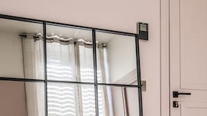 A room with a large mirror, a sliding door, and a light-colored wooden floor. - Maison Aribert (Saint-Martin-d'Uriage)