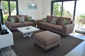 A living room with two sofas, a coffee table, and an ottoman.