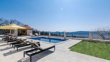 Seasonal outdoor pool, pool umbrellas, pool loungers