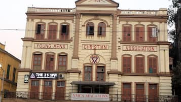 A building with signs for 'Young Mens Christian Association' and 'YMCA SEAC M Inn'.