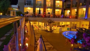 A hotel with outdoor seating, a pool, and multiple balconies. - Life Elite Hotel (Manavgat)