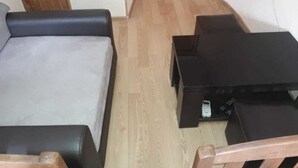 A small room with a bed, a wooden chair, a small table, and a black cabinet. - Apartment on Lermontov Str. (Tbilisi)
