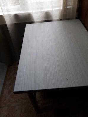 A room with a large, rectangular table and a window with sheer curtains. - Apartment on Lermontov Str. (Tbilisi)