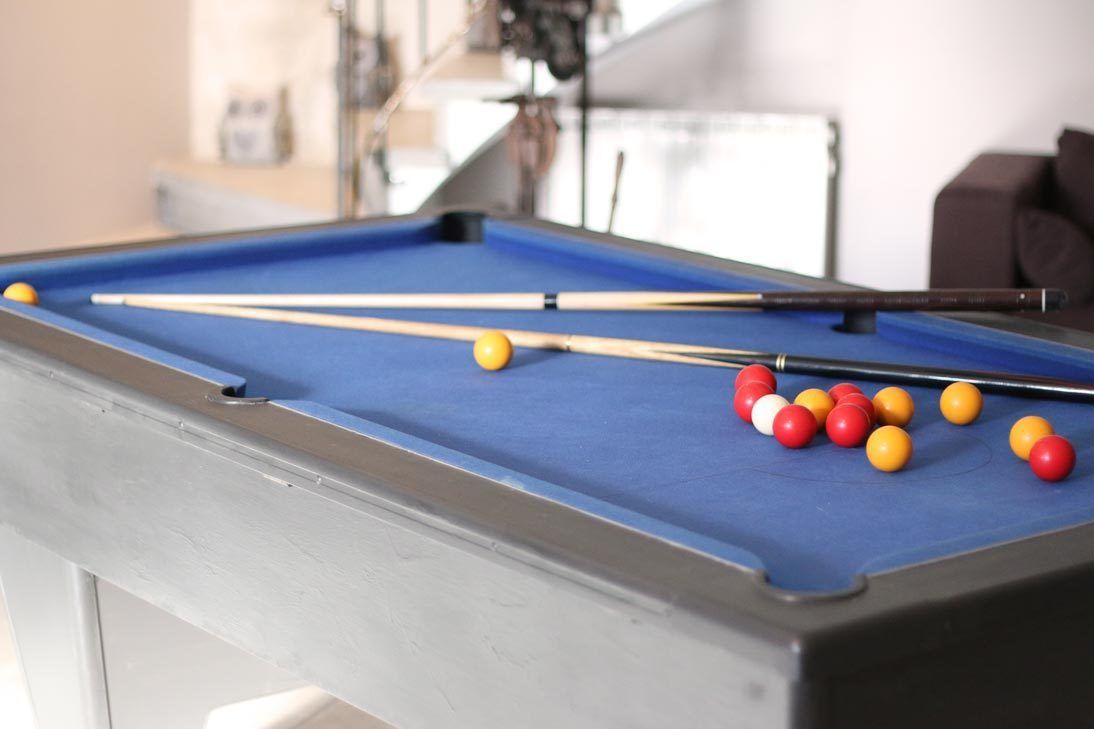 A pool table with balls and cues.