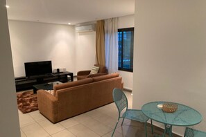 Apartment, 1 Bedroom | Living area | 40-inch flat-screen TV with satellite channels, TV - Guest House T2 (Abidjan)