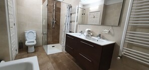 Bathtub, towels, soap, toilet paper