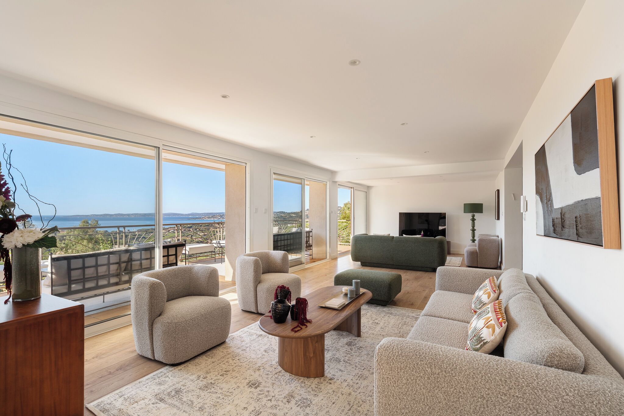 A spacious living room with a large window, a wooden coffee table, and a sofa.