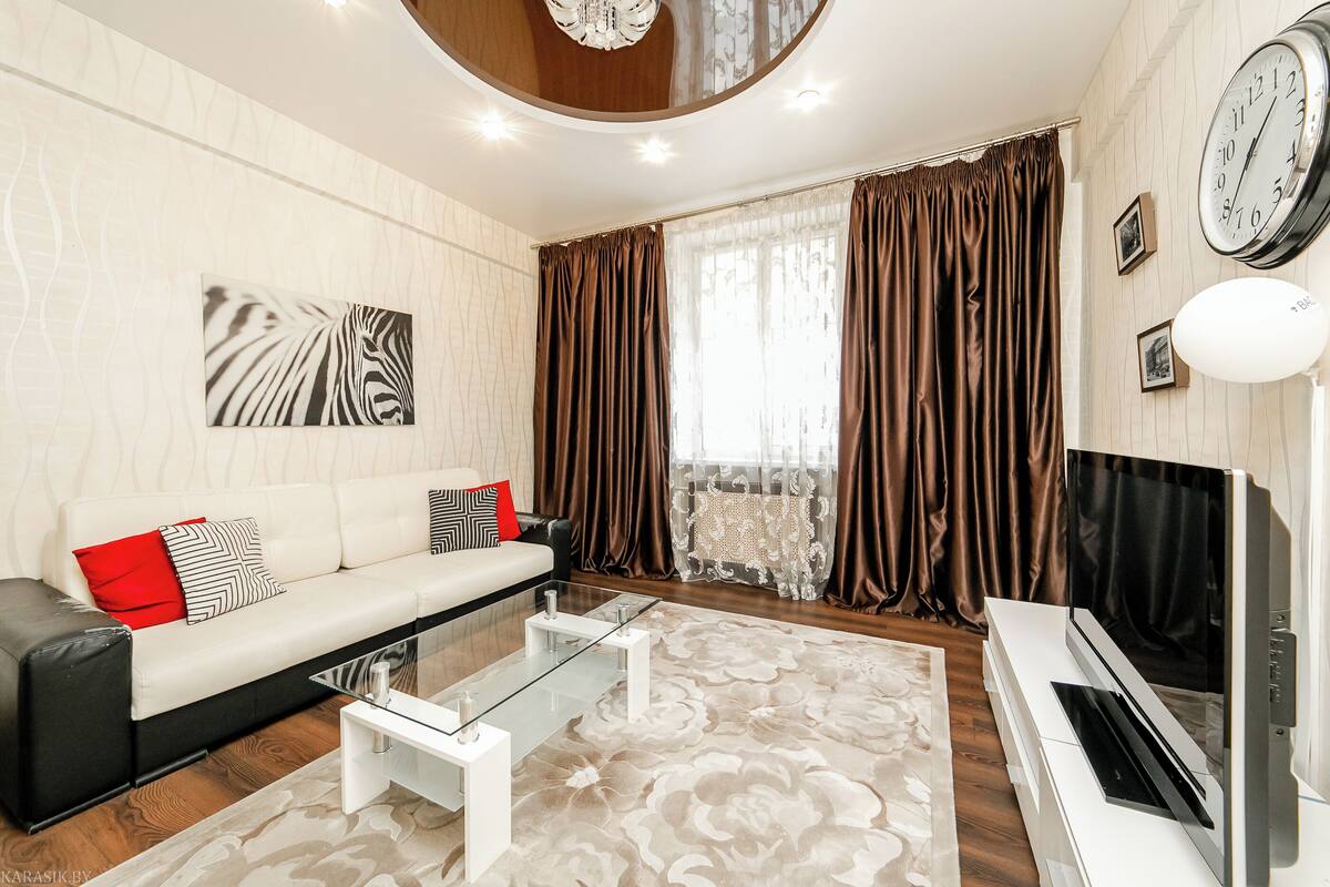A modern living room with a sofa, coffee table, and a flat-screen TV.