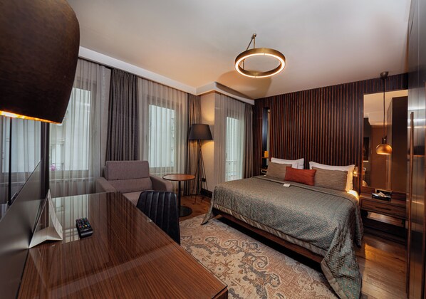 A modern hotel room with a large bed, a desk, and a sofa. - Levni Plus Hotel (Istanbul)