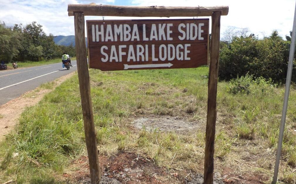 A wooden sign indicating the direction to Ihamba Lake Side Safari Lodge.