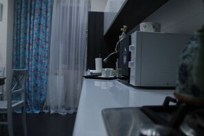 Standard Apartment (10 Giorgi Kuchishvili Street 2) | Private kitchen | Full-sized fridge, microwave, cookware/dishes/utensils - Apartment on Kuchishvili Str. (Tbilisi)