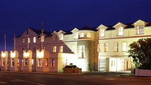 A multi-story hotel with a stone facade and multiple windows.
