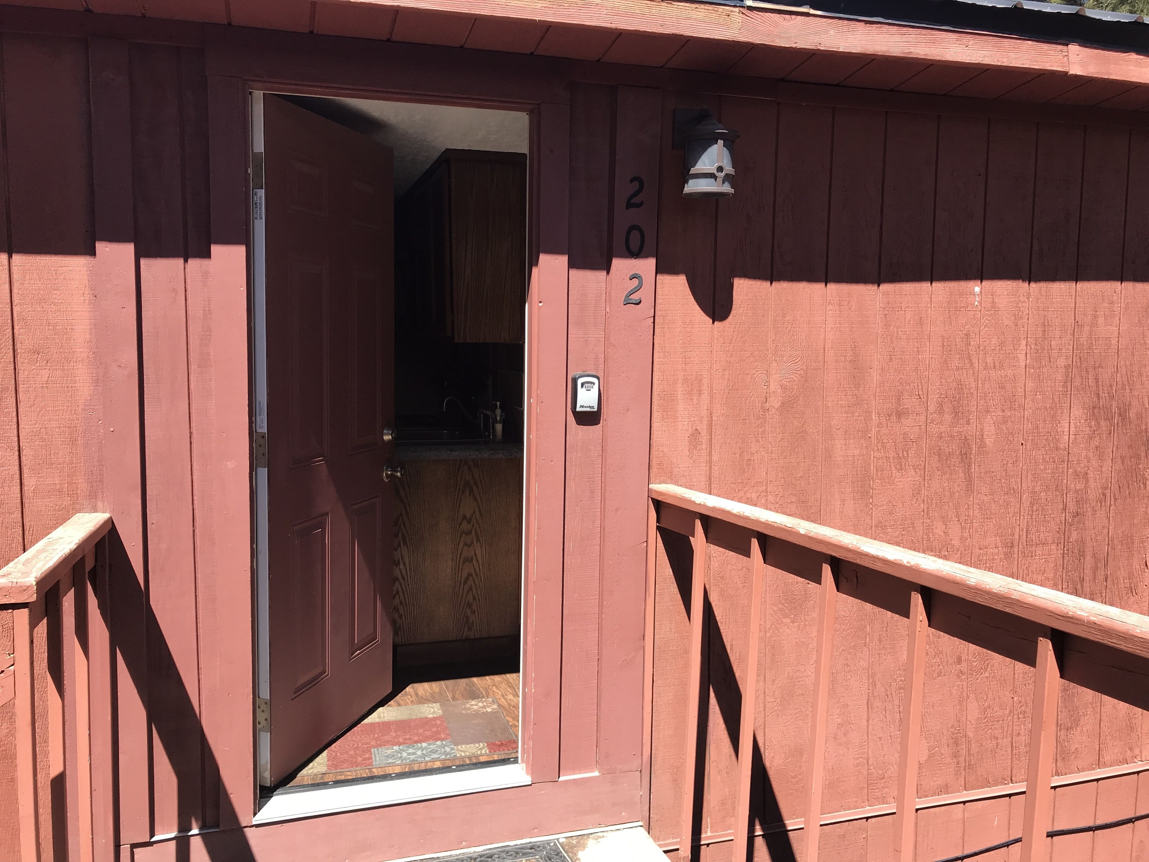 A wooden building with a door leading to a kitchen area.