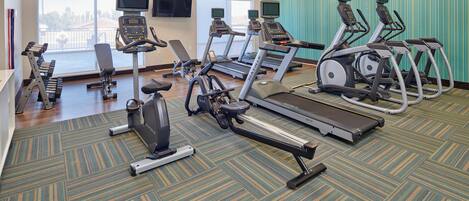 A fitness center with treadmills, elliptical machines, and weight machines.