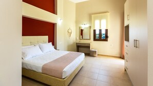 A bedroom with a bed, a vanity, a mirror, and a television. - Anatoli Villa, a Retreat with Private Pool & BBQ (Rethymno)