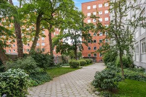 Stroll through the serene courtyard surrounded by lush greenery and modern architecture.