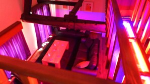 A staircase with a wooden handrail and a small table with a cushion. - Loft in Red Light District (Antwerpen)