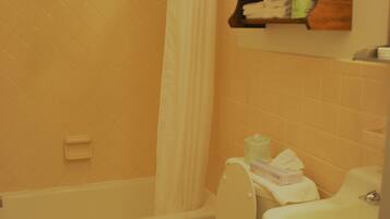 A bathroom with a bathtub, a toilet, and a sink.