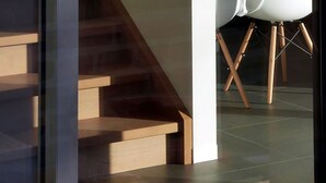 A modern interior with a staircase leading to a dining area.