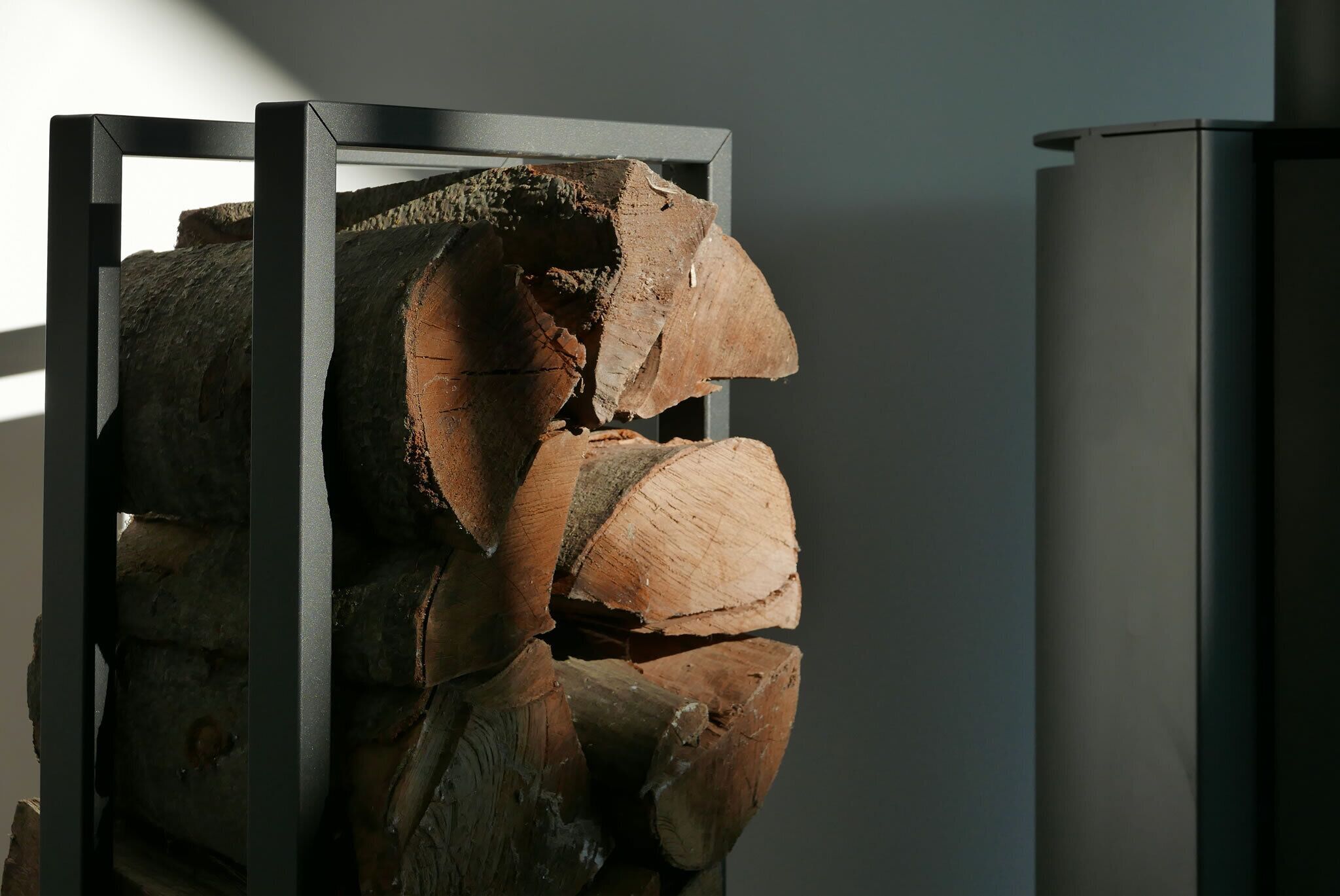 A stack of logs in a metal frame structure.