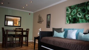 A bedroom with a bed, a desk, and chairs. - 411  Near Disney Charming Spot! (Kissimmee)
