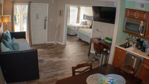 A compact living space with a kitchenette, a dining area, and a bedroom. - 411  Near Disney Charming Spot! (Kissimmee)