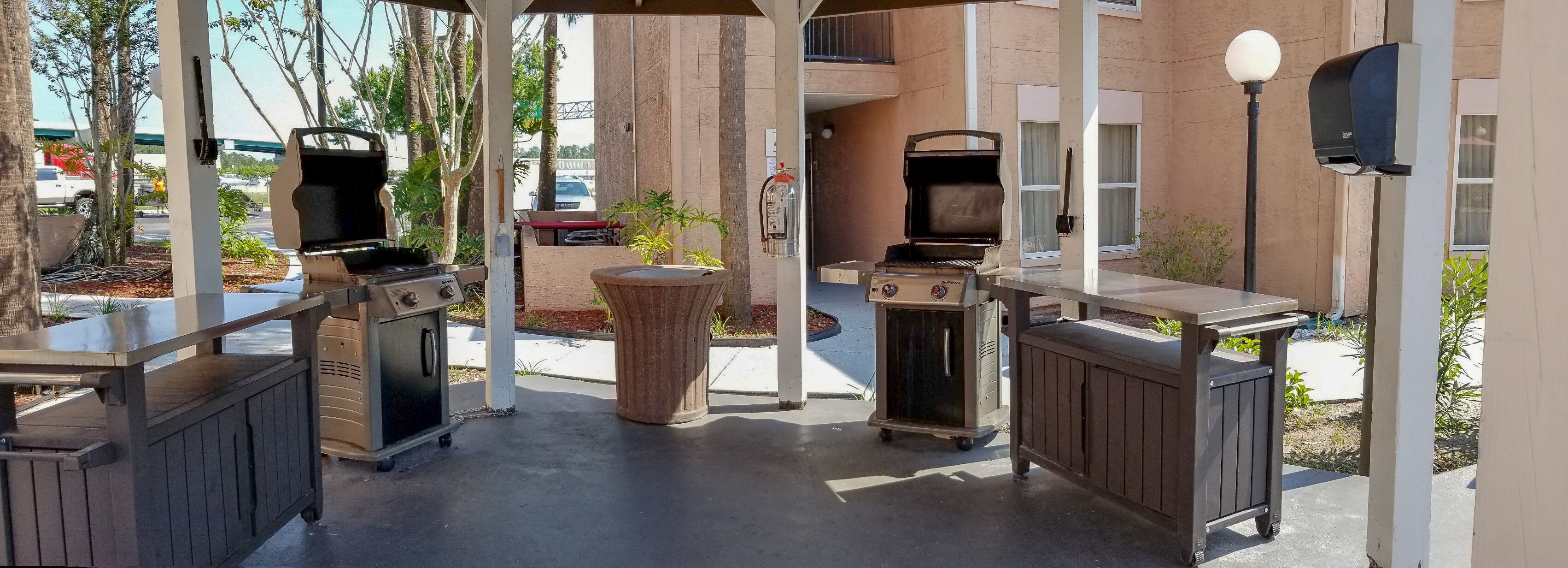 Outdoor barbecue grills, a trash can, and a mailbox.