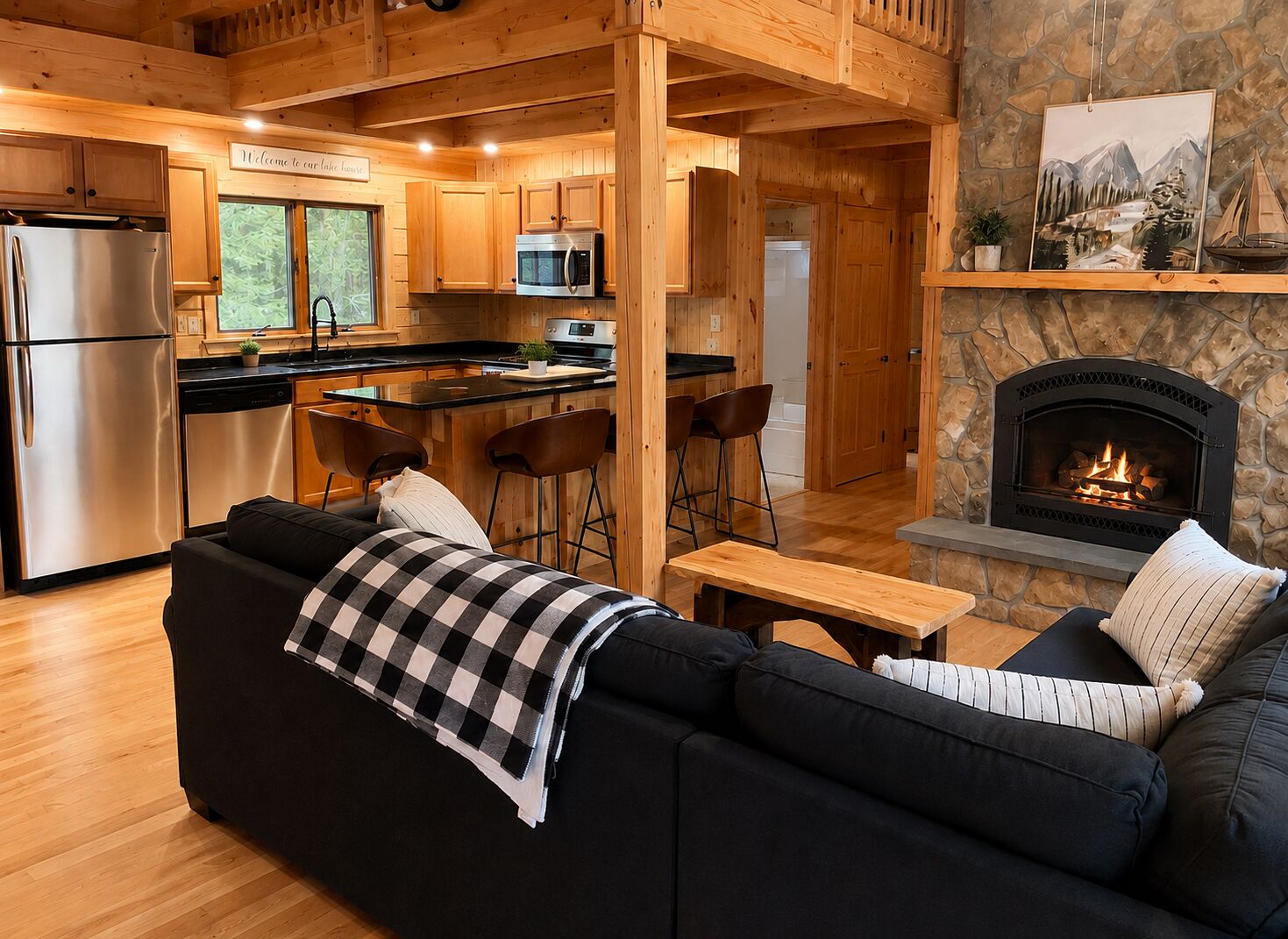 A cozy cabin interior with a kitchen, dining area, and a fireplace.
