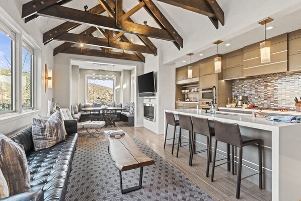 A modern kitchen with a large island, bar stools, and a built-in oven. - Abode at Powder Watch, private hot tub, heart of Park City, near ski lift (Park City)
