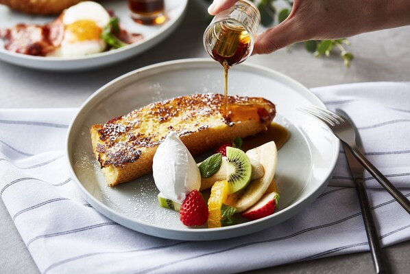 A plate with French toast, whipped cream, and sliced fruit. - slash kawasaki (Kawasaki)