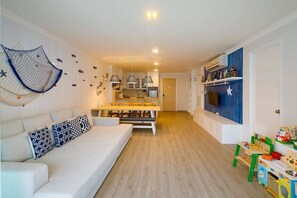 2-Bedroom Apartment | Living area | Flat-screen TV