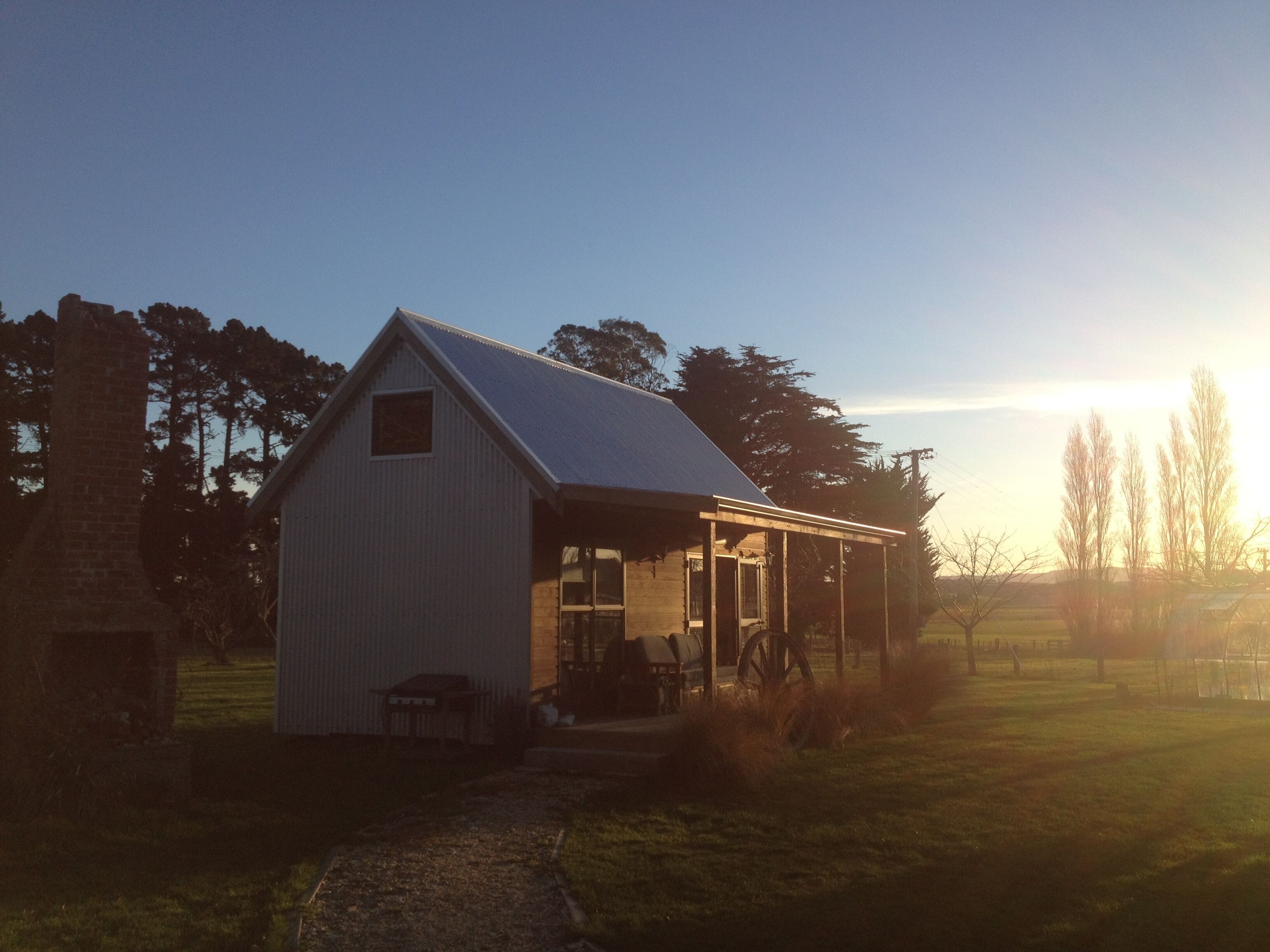 A small, single-story building with a sloped roof and a covered porch.